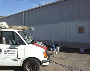 Tall commercial building being painted
