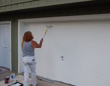 Gary applying a fresh coat of paint to an exterior